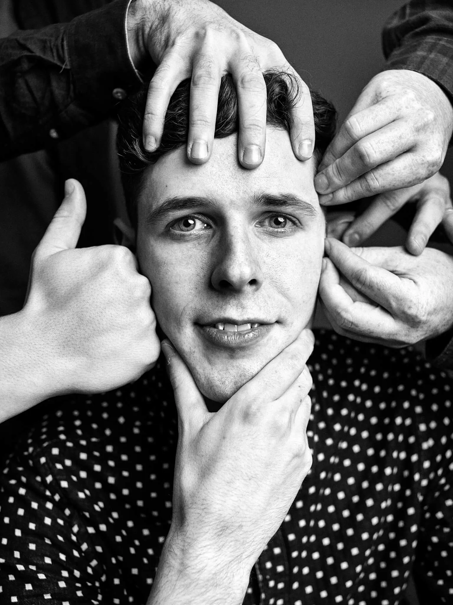 Chris Cope, with his bandmates' hands all over his face