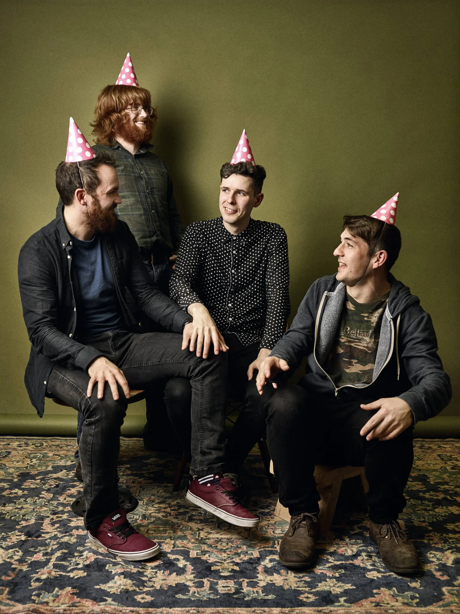 Trookers in pink party hats, laughing together