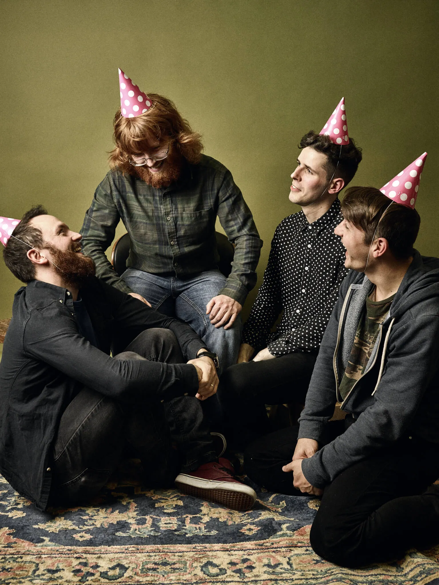 Trookers in pink party hats, sat on the floor swapping stories